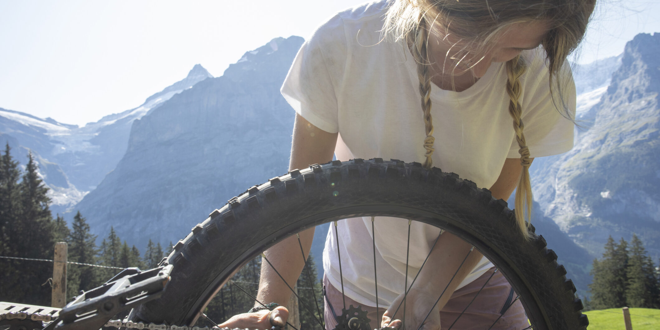 Young woman performs bike mechanics on e-bike