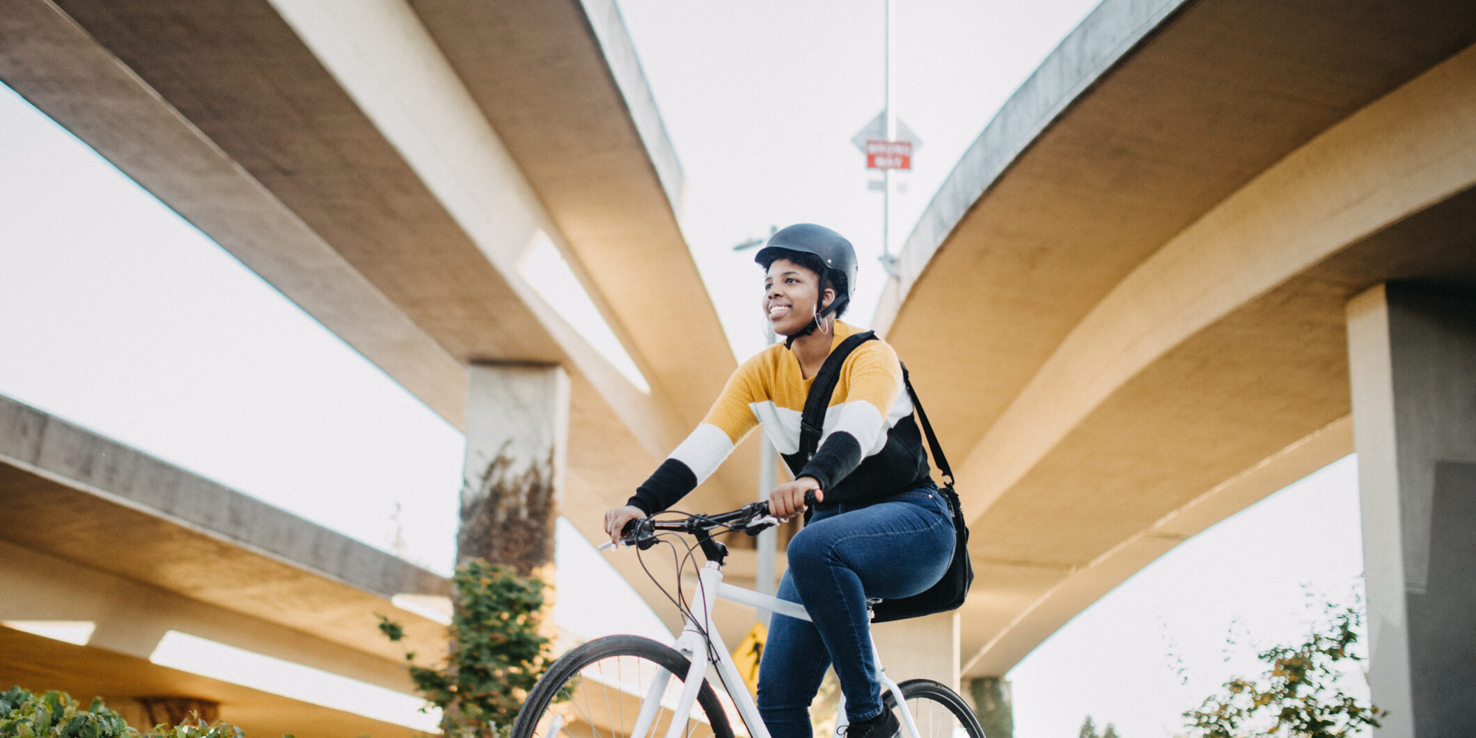 Young Woman With Bike and Messenger Bag in The City