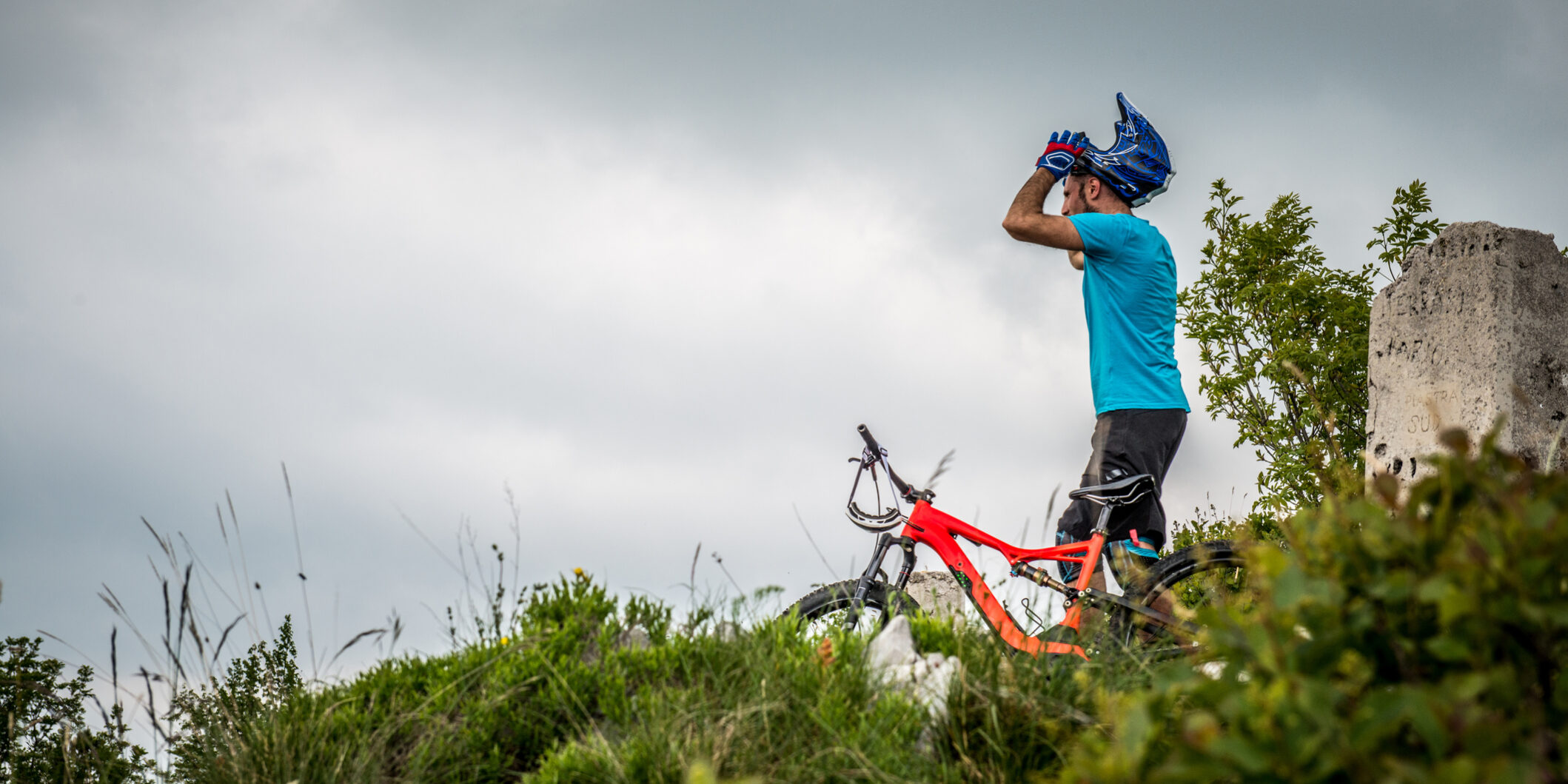 Portrait of Enduro All Mountain E bike rider – adrenaline MTB trail – correcting helmet