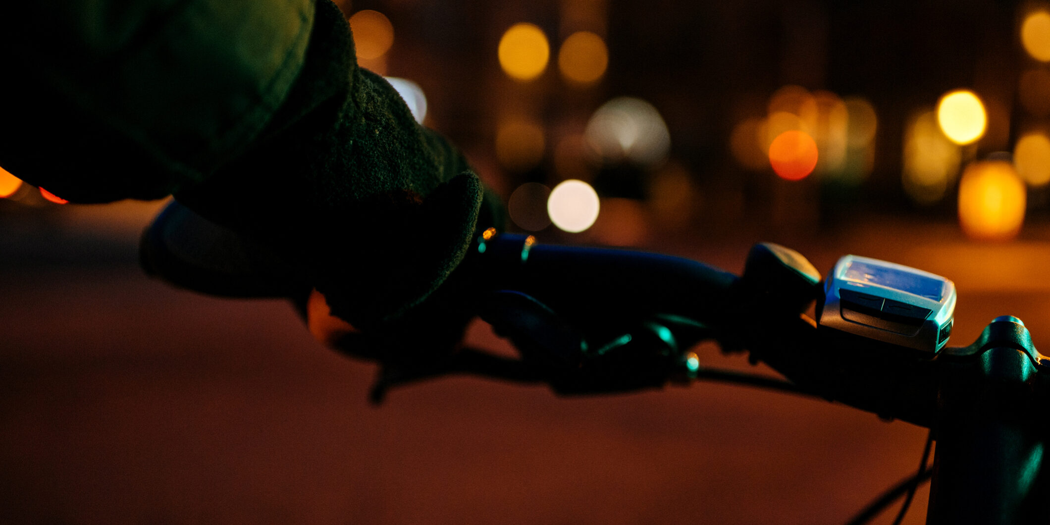 biker cyclist holding steering night electric defocused background city