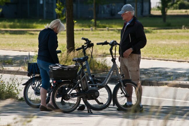 Elderly Couple Cyclists Prepare Their Hercules Branded Electric Bicycles In Phoenix See Hoerde – Dortmund, Germany