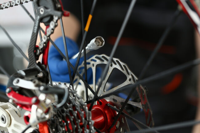 Technician Repair Speed Bike at Workshop Close-up