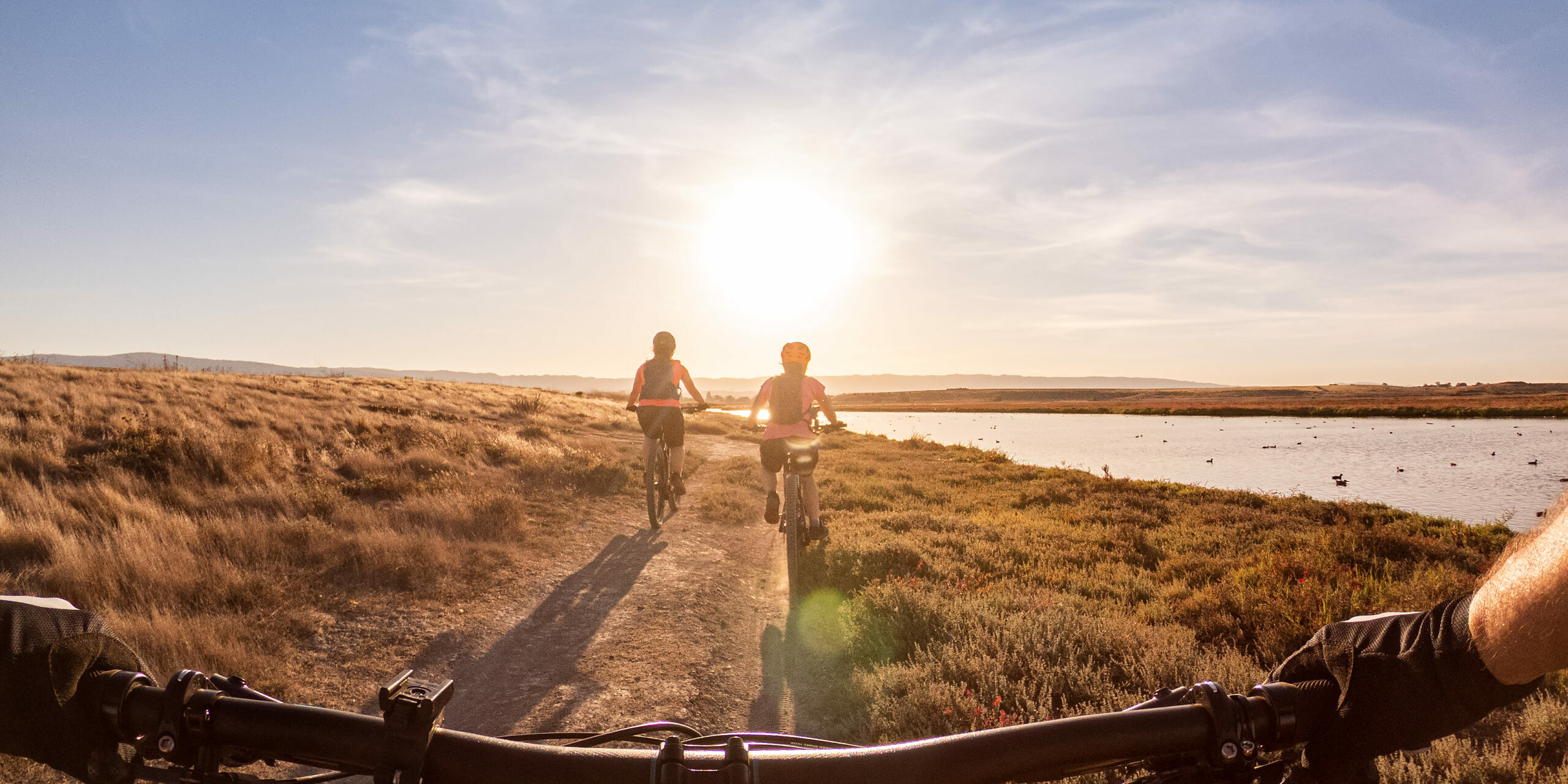 POV of Family Biking Along Shoreline Trail, California, USA